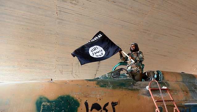 Image 1: <p>The Islamic State flag, which is black and features white text saying “There is no God but Allah”. Photo: AP