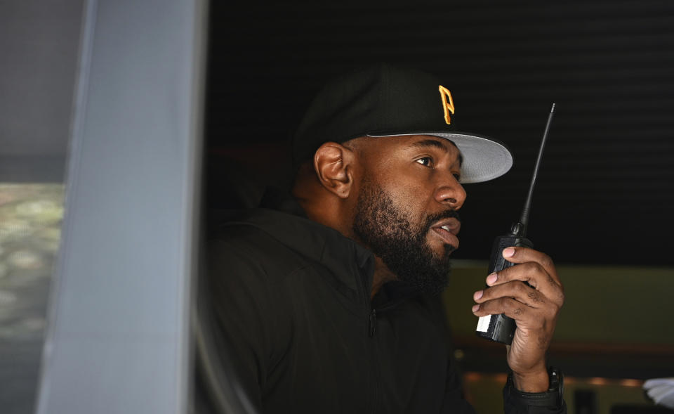 This image released by Netflix shows director Antoine Fuqua working from a vehicle on the set of "The Guilty." (Glen Wilson/Netflix via AP)