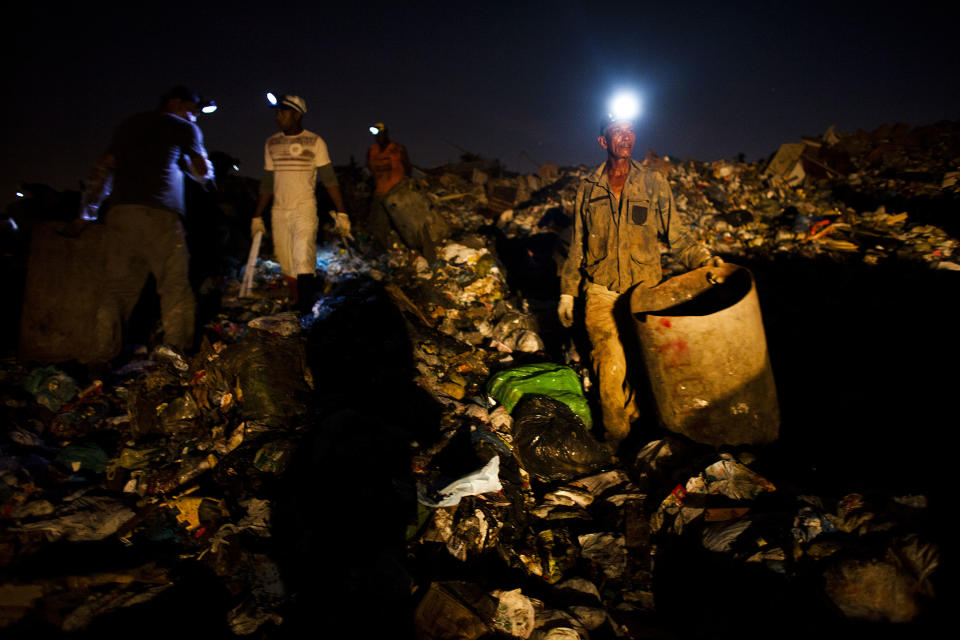 In this May 29, 2012 photo, Walter Barbosa, 60, waits for a trash truck to unload at Jardim Gramacho, one of the world's largest open-air landfills, in Rio de Janeiro, Brazil. Jardim Gramacho, a vast, seaside mountain of trash where thousands of people made a living sorting through the debris by hand, is closing after three decades in service. (AP Photo/Victor R. Caivano)