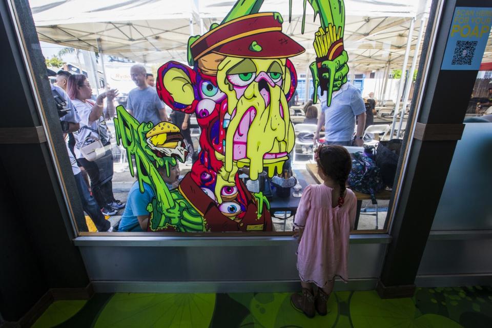 A girl looks out at the patio scene at pop-up burger stand Bored & Hungry.