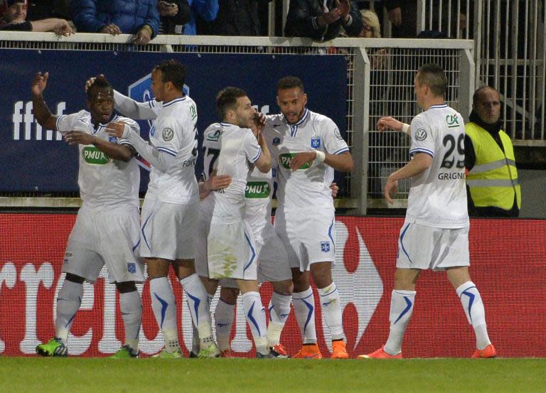 Auxerre players celebrates after scoring during the French Cup match against Guingamp on April 7, 2015 at the l'Abbe-Deschamps stadium