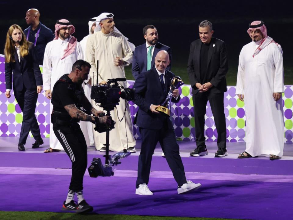 Gianni Infantino with the trophy during the ceremony after the Club World Cup final (Reuters)