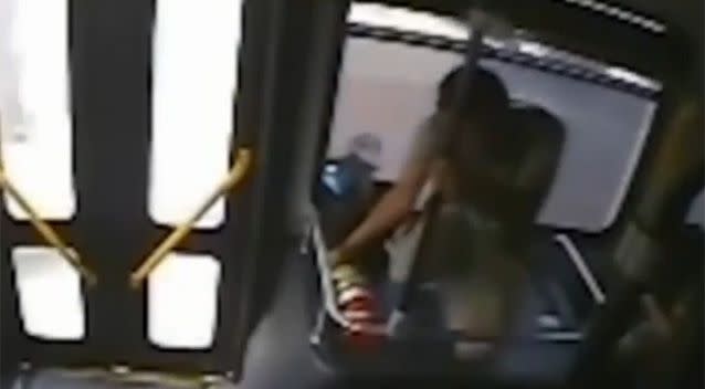 The suspect was seen grabbing a fire extinguisher on board the bus. Photo: YouTube