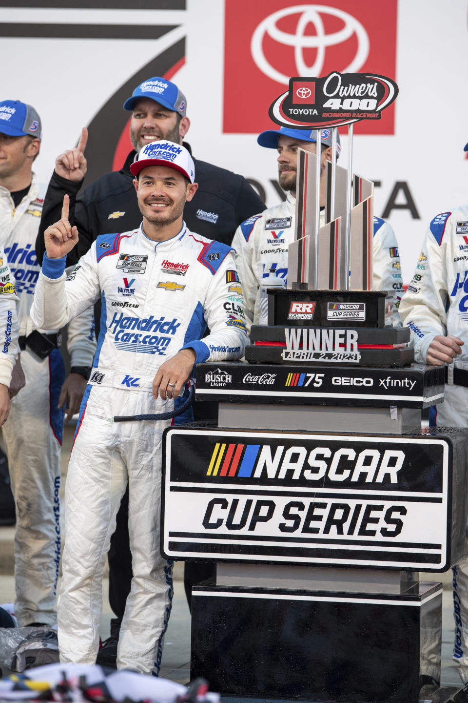 Kyle Larson stands next to his trophy after winning a NASCAR Cup Series auto race at Richmond Raceway, Sunday, April 2, 2023, in Richmond, Va. (AP Photo/Mike Caudill)