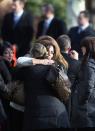 NEWTOWN, CT - DECEMBER 18: Mourners embrace after a funeral for Jessica Rekos, 6, at the St. Rose of Lima Catholic church on December 18, 2012 in Newtown, Connecticut. Funeral services were held at the church for both Jessica Rekos and James Mattioli, 6, Tuesday, four days after 20 children and six adults were killed at Sandy Hook Elementary School. (Photo by John Moore/Getty Images)