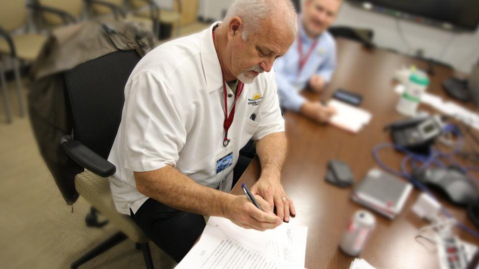 Volusia County Manager George Recktenwald signs the curfew extension for Tropical Storm Ian until 7 a.m. Friday, Sept. 30, at the Emergency Operations Center in Daytona Beach, Thursday, Sept. 29, 2022.