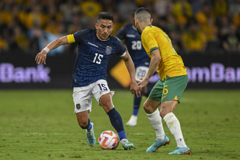 Mitchell Duke, right, of Australia and Angel Mena of Ecuador battle for the ball during a friendly soccer international between Ecuador and Australia in Sydney, Friday, March 24, 2023. (Dean Lewins/AAPImage via AP)
