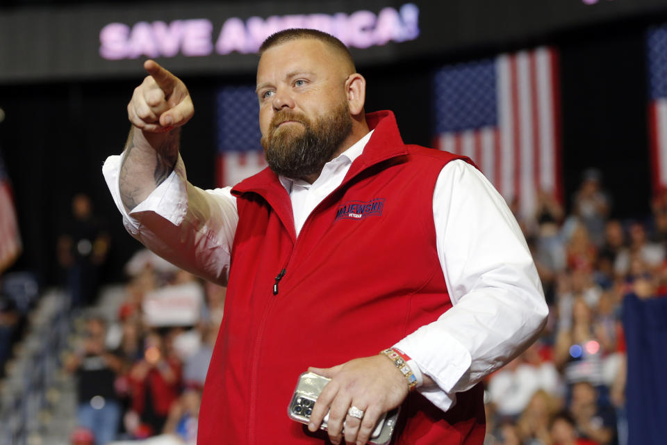 J.R. Majewski stands onstage at a rally.