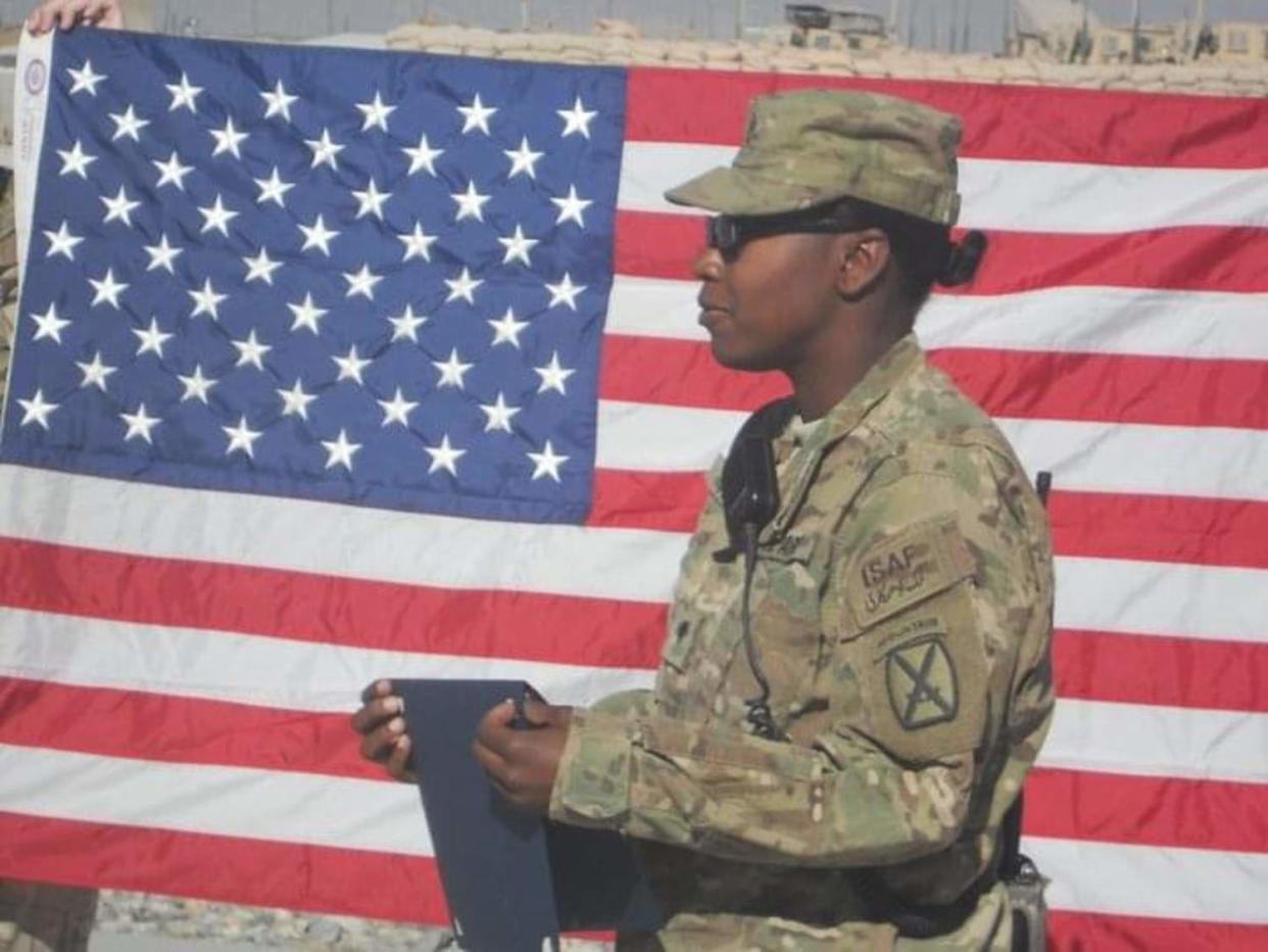 Daphne Young in front of American flag  (Courtesy Daphne Young )