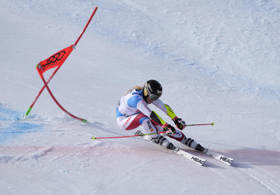 Switzerland's Lara Gut-Behrami powers pasta gate on her way to win a women's giant slalom, at the alpine ski World Championships in Cortina d'Ampezzo, Italy, Thursday, Feb. 18, 2021. (AP Photo/Giovanni Auletta)