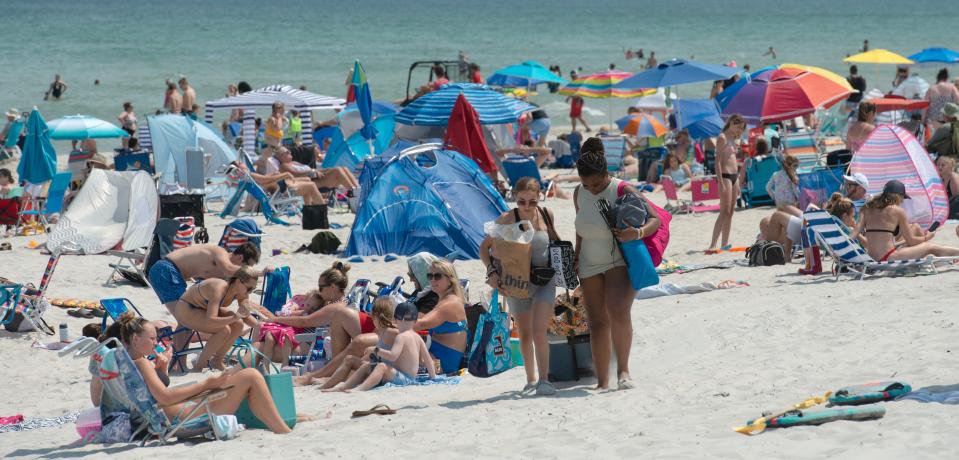 Mayflower Beach in Dennis fills up on a hot weekday morning, June 20, 2024, as beachgoers seek relief from the heat.