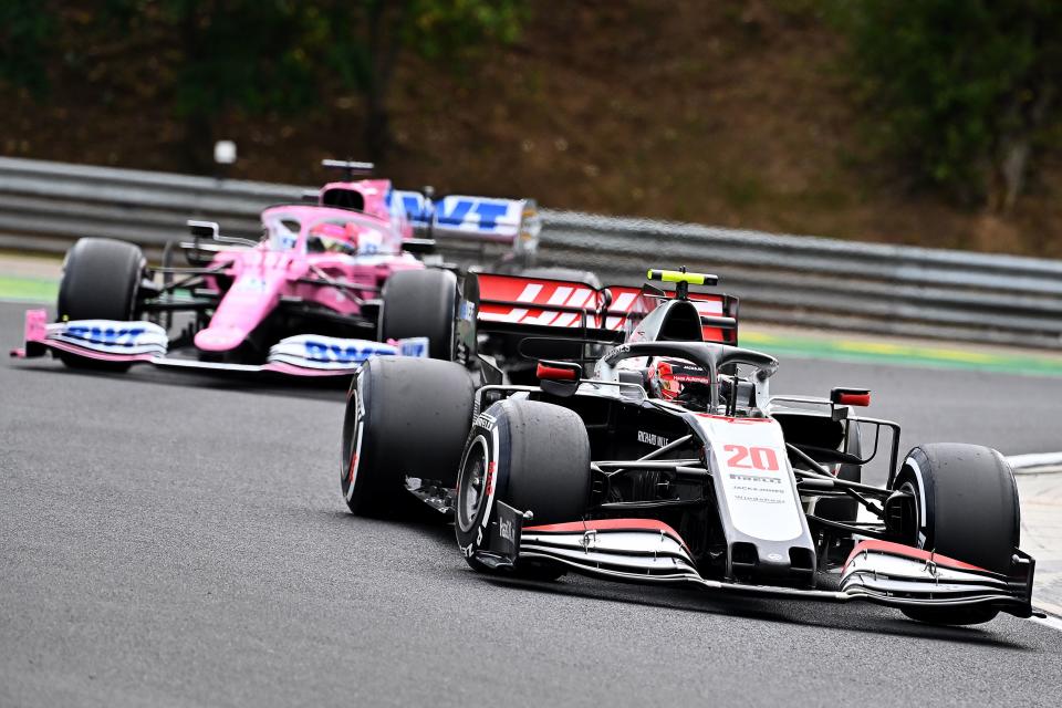 Haas F1's Danish driver Kevin Magnussen steers his car in front of Racing Point's Mexican driver Sergio Perez during the Formula One Hungarian Grand Prix race at the Hungaroring circuit in Mogyorod near Budapest, Hungary, on July 19, 2020. (Photo by Joe Klamar / POOL / AFP) (Photo by JOE KLAMAR/POOL/AFP via Getty Images)