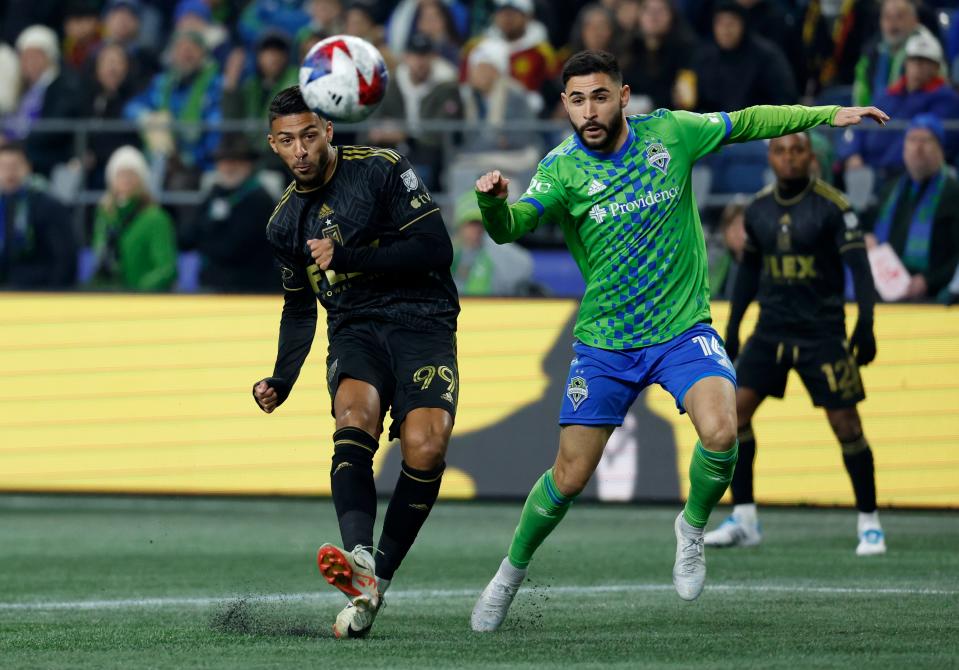 Los Angeles FC's Denis Bouanga (99) shoots as the Seattle Sounders' Alex Roldan (16) defends during the 2023 Western Conference semifinal at Lumen Field. LAFC won that game, 1-0, en route to a second straight MLS Cup appearance.