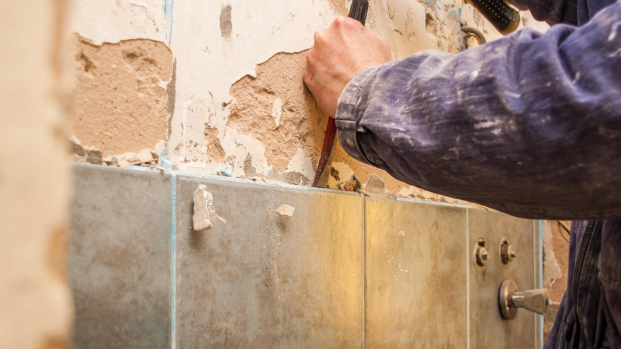 tile worker takes off bad tile