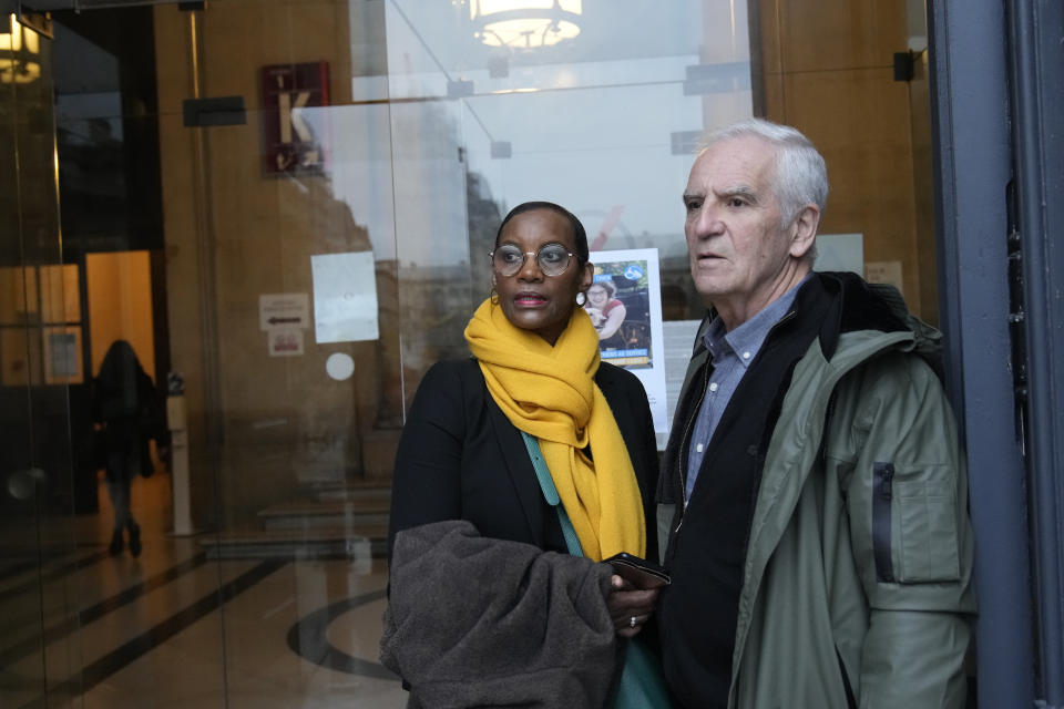 President of the Collective of Civil Parties for Rwanda Alain Gauthier and his wife Dafroza wait at Paris court house, Thursday, Nov. 23, 2023 as Sosthene Munyemana, a Rwandan doctor arrives on trial over his alleged role in the 1994 genocide in his home country. Munyemana who has been living in France for decades faces charges of genocide, crimes against humanity and complicity in such crimes. (AP Photo/Christophe Ena)