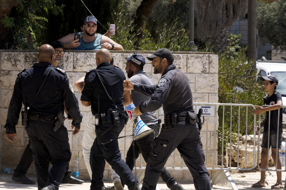 Police arrest an Israeli activist at a protest near the home of far-right National Security Minister Itamar Ben Gvir against plans by Benjamin Netanyahu's government efforts to overhaul the judiciary, in the West Bank settlement of Kiryat Arba, Friday, Aug. 25, 2023. (AP Photo/Maya Alleruzzo)