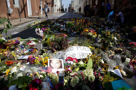 Flowers are pictured on the street where Heather Heyer was killed when a suspected white nationalist crashed his car into anti-racist demonstrators in Charlottesville, Virginia, U.S., August 16, 2017. REUTERS/Joshua Roberts