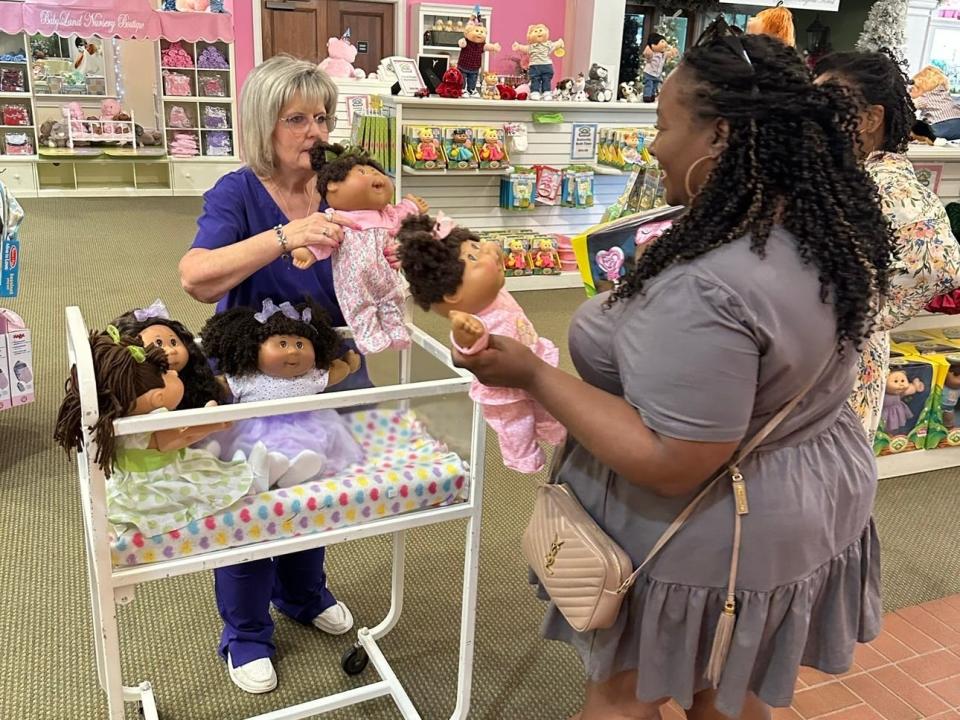 The author and her friend adopting Cabbage Patch dolls.