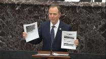 In this image from video, House impeachment manager Rep. Adam Schiff, D-Calif., holds redacted documents as he speaks during the impeachment trial against President Donald Trump in the Senate at the U.S. Capitol in Washington, Wednesday, Jan. 22, 2020. (Senate Television via AP)