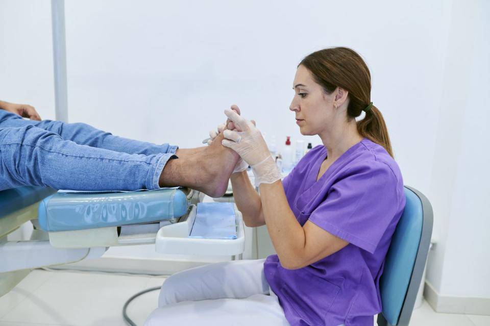 podiatrist curing patient callus in clinic