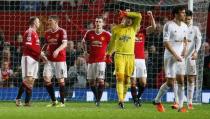 Football Soccer - Manchester United v Swansea City - Barclays Premier League - Old Trafford - 2/1/16 Swansea's Lukasz Fabianski looks dejected as Manchester United players celebrate at the end of the match Reuters / Andrew Yates Livepic