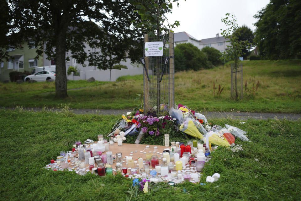 Flowers are left at the scene of a shooting in the Keyham area of Plymouth, England, Saturday, Aug. 14, 2021. Britain’s police watchdog says it has launched an investigation into why a 22-year-old man who fatally shot five people in southwestern England was given back his confiscated gun and gun license. Police have said Jake Davison killed his mother and four other people, including a 3-year-old girl, before taking his own life in Plymouth. (Ben Birchall/PA via AP)