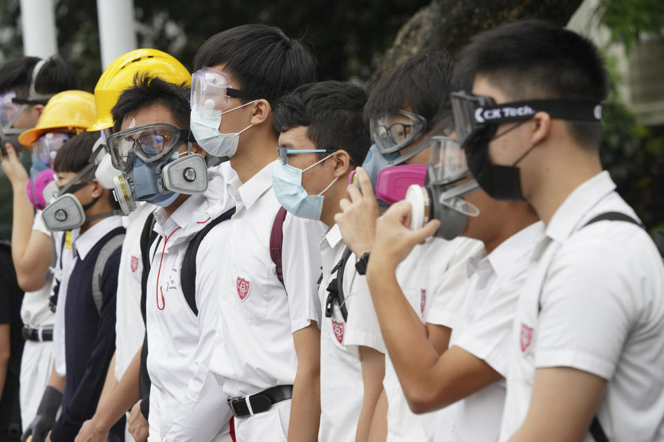 Students wearing gas masks and helmets stage a rally outside Queen's College in Hong Kong, on Monday, Sept. 2, 2019. Hong Kong has been the scene of tense anti-government protests for nearly three months. The demonstrations began in response to a proposed extradition law and have expanded to include other grievances and demands for democracy in the semiautonomous Chinese territory. (AP Photo)