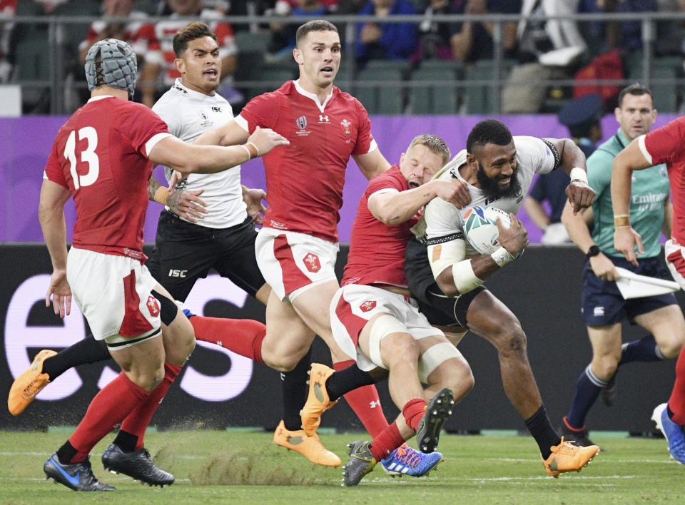 Fiji's Waisea Nayacalevu is tackled by the Welsh defence during the Rugby World Cup Pool D game at Oita Stadium between Wales and Fiji in Oita, Japan, Wednesday, Oct. 9, 2019. (Kyoto via AP)/Kyodo News via AP)