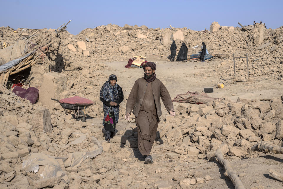 Afghan people walk amid destruction after an earthquake in Zenda Jan district in Herat province, western Afghanistan, Wednesday, Oct. 11, 2023. Another strong earthquake shook western Afghanistan on Wednesday morning after an earlier one killed more than 2,000 people and flattened whole villages in Herat province in what was one of the most destructive quakes in the country's recent history. (AP Photo/Ebrahim Noroozi)