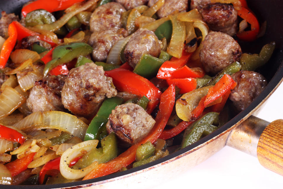 A skillet of beef with peppers and onions