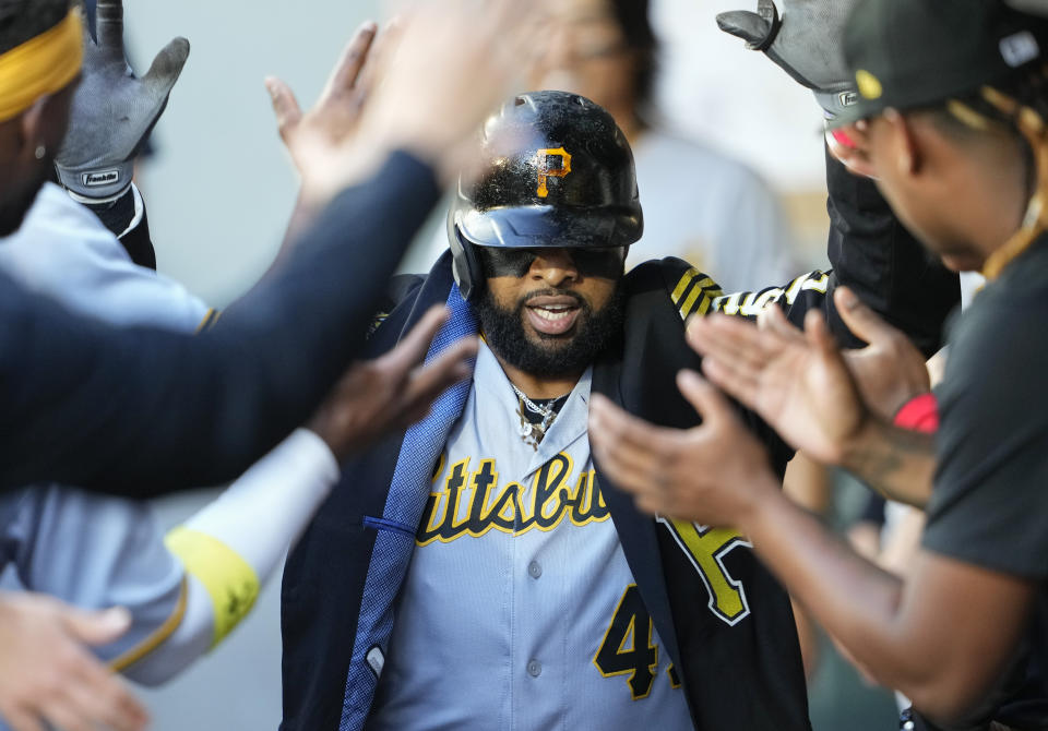 Pittsburgh Pirates' Carlos Santana wears a jacket as he celebrates his home run against the Seattle Mariners during the fourth inning of a baseball game, Friday, May 26, 2023, in Seattle. (AP Photo/Lindsey Wasson)