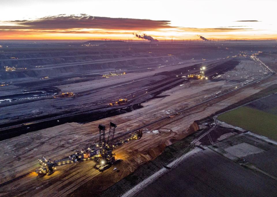 FILE - Bucket wheel excavators mine coal at the Garzweiler open-cast coal mine in Luetzerath, Germany, Oct. 25, 2021. Germany is shutting down its last three nuclear power plants on Saturday, April 15, 2023, as part of an energy transition agreed by successive governments. Critics have warned that without nuclear power, Germany will have to rely on dirty coal and gas plants for energy during periods of overcast but calm weather. (AP Photo/Michael Probst, File)