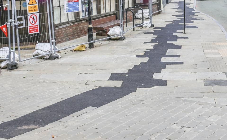 Residents of Oswestry criticised the workmen who replaced paving stones with tarmac. (SWNS)