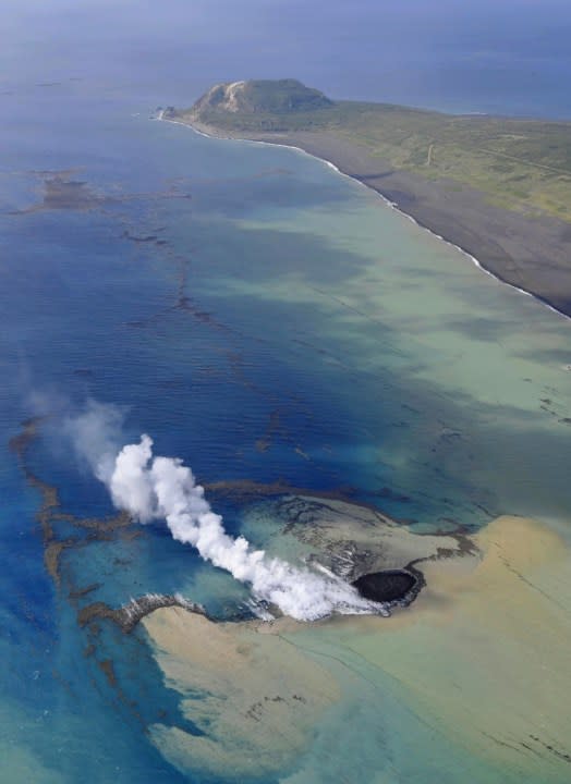 In this aerial photo, smoke billows from the water off the Ioto island, following an eruption in Ogasawara, southern Tokyo, Japan on Oct. 30, 2023. An unnamed undersea volcano, located about 1 kilometer (half a mile) off the southern coast of Iwo Jima, which Japan calls Ioto, started its latest series of eruptions on Oct. 21. (Kyodo News via AP)