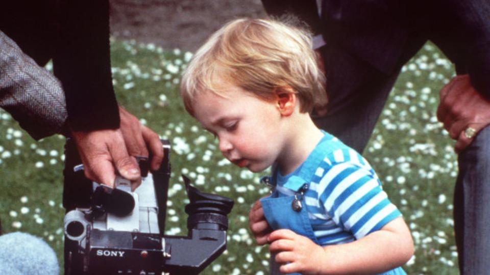 Prince William looking at a TV camera during a photo-call with his parents in the gardens of Kensington Palace, London