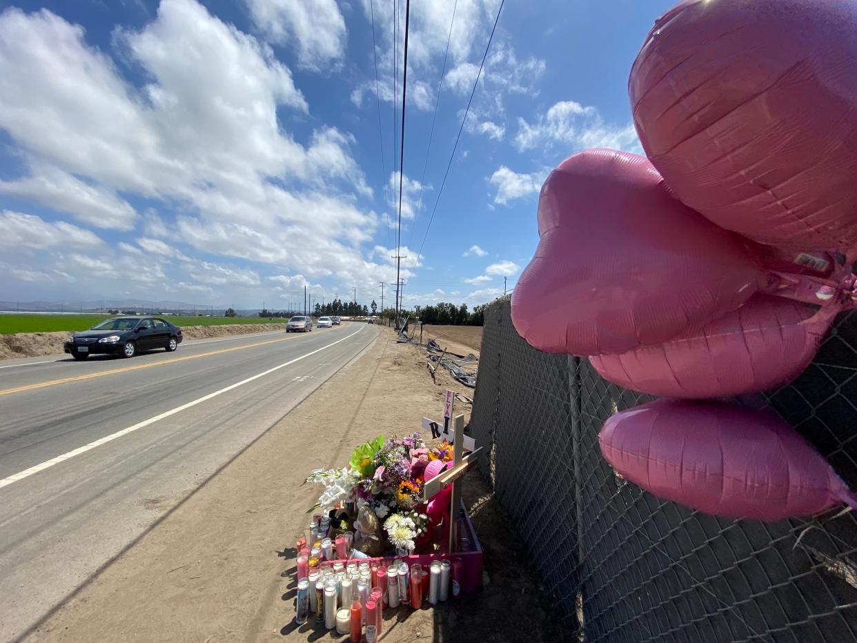 Damaged fencing along Pleasant Valley Road is visible in 2020 beyond a roadside memorial for Nevaeh Gomez, 7, and her grandmother, Elva Andrade, 55, who were killed when an alleged DUI driver hit their scooter head-on. A jury is now deliberating two counts of second-degree murder against the driver.