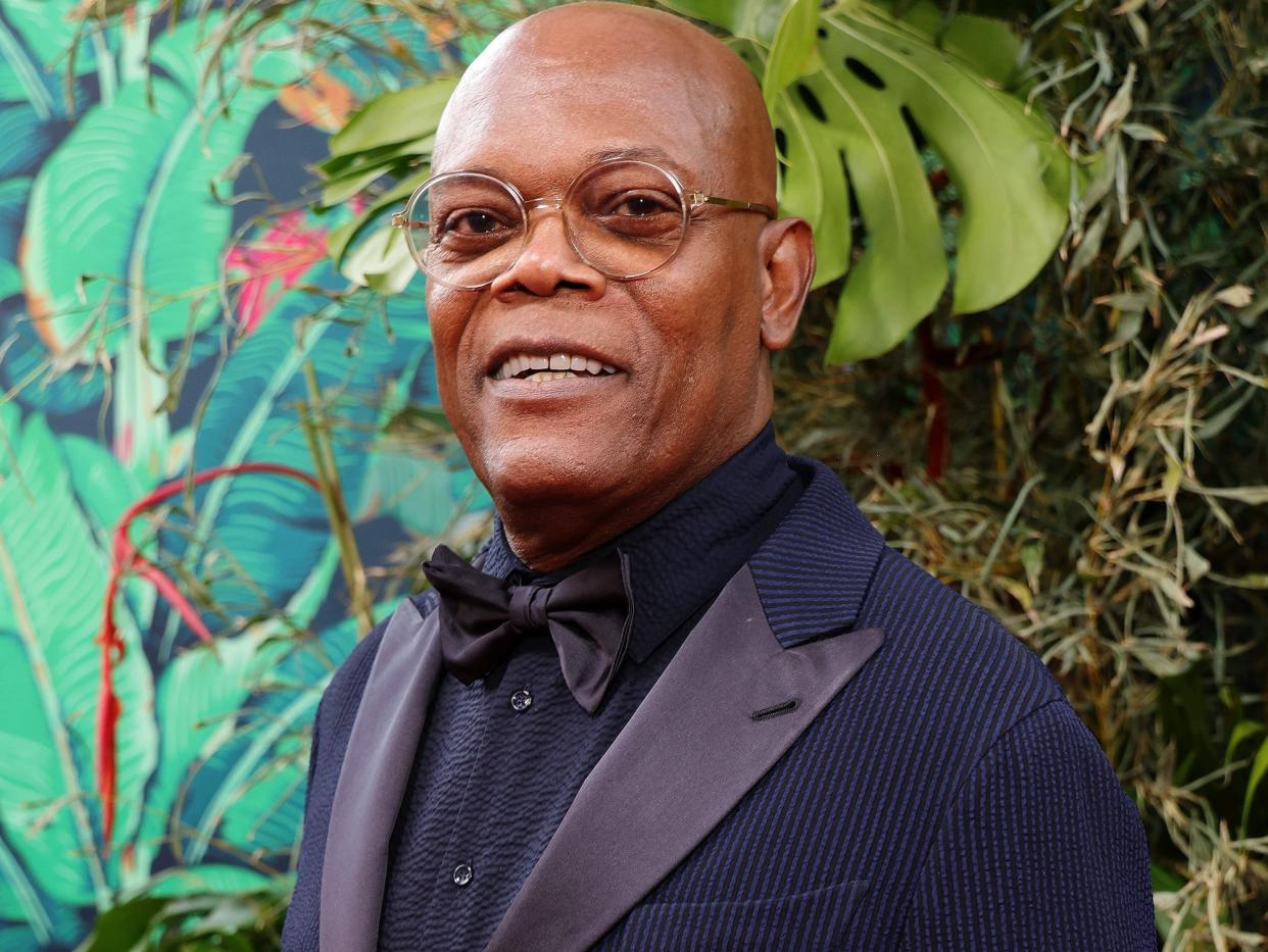Samuel L. Jackson poses for photos in a midnight blue suit and bowtie in 2023.