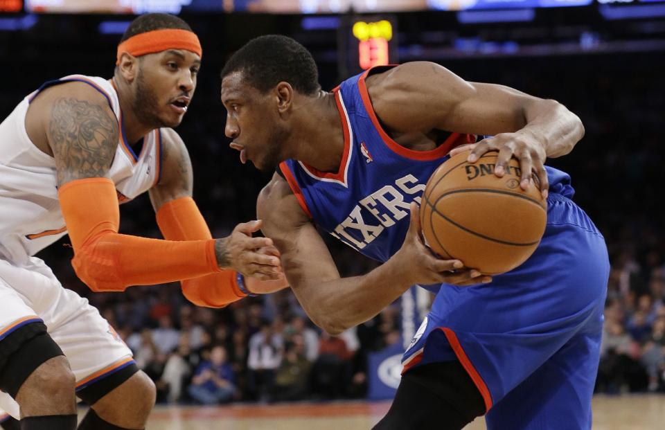 New York Knicks' Carmelo Anthony (7) defends Philadelphia 76ers' Thaddeus Young (21) during the second half of an NBA basketball game Monday, March 10, 2014, in New York. (AP Photo/Frank Franklin II)