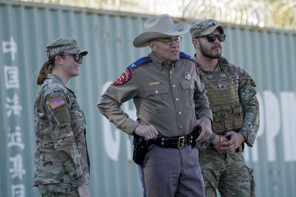 Texas Department of Public Safety chief Steve McCraw, center, stands with officials as they wait for the arrival of Congressional members, Wednesday, Jan. 3, 2024, in Eagle Pass, Texas. U.S. House Speaker Mike Johnson is leading about 60 fellow Republicans in Congress on a visit to the Mexican border. Their trip comes as they are demanding hard-line immigration policies in exchange for backing President Joe Biden's emergency wartime funding request for Ukraine. Senate negotiators in Washington are plugging away in hopes of a bipartisan deal. The number of illegal crossings into the United States topped on several days last month. (AP Photo/Eric Gay)