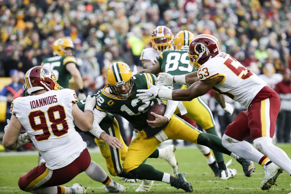 Green Bay Packers' Aaron Rodgers is sacked by Washington Redskins' Jon Bostic (53) and Matthew Ioannidis (98) during the second half of an NFL football game Sunday, Dec. 8, 2019, in Green Bay, Wis. The Packers won 20-15. (AP Photo/Mike Roemer)