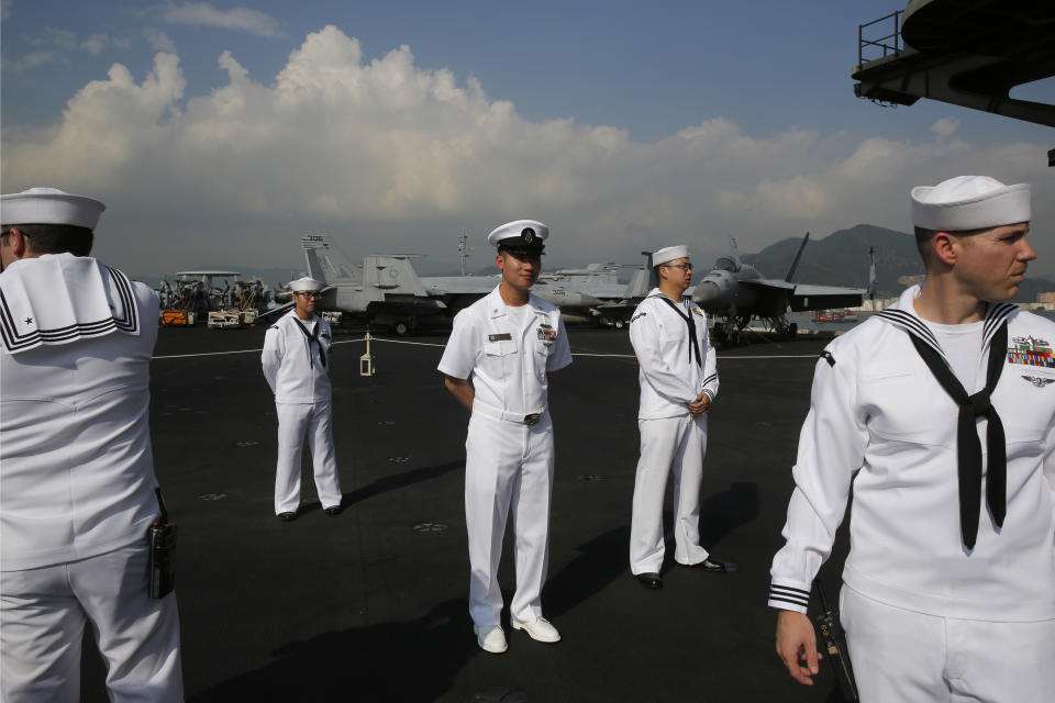 U.S. Navy sailors stand on the deck of the USS Ronald Reagan aircraft carrier in Hong Kong, Wednesday, Nov. 21, 2018. The USS Reagan docked in Hong Kong on Wednesday, days after a pair of American B-52 bombers flew over the disputed South China Sea. (AP Photo/Kin Cheung)