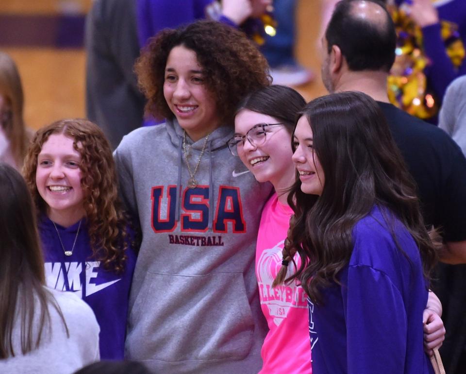 Lubbock Monterey junior Aaliyah Chavez, near left, poses for pictures with fans after the Lady Plainsmen beat Abilene Wylie 58-43 in a District 4-5A girls basketball game Tuesday at Bulldog Gym in Abilene.