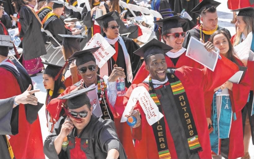 Rutgers University graduates celebrate as they proceed into HighPoint.com Stadium in Piscataway for the commencement ceremony on Sunday, May 19, 2019.