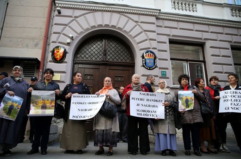 FILE PHOTO: Representatives of the Association of Victims and Witnesses of Genocide hold a picture of the winner of the 2019 Nobel Prize for Literature Peter Handke in Srebrenica, during a protest in front of Sweden embassy in Sarajevo