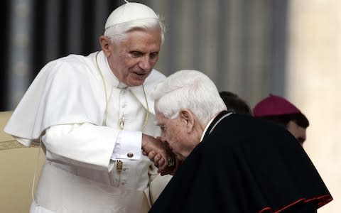 Cardinal Bernard Law, right, kisses Pope Benedict XVI's hand at the end of the weekly general audience in St. Peter's Square at the Vatican, in 2006 - Credit:  Plinio Lepri/AP