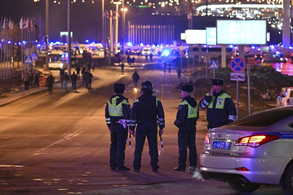 Police block the road to the Crocus City Hall on the western edge of Moscow, Russia, Friday, March 22, 2024. Several gunmen have burst into a big concert hall in Moscow and fired automatic weapons at the crowd, injuring an unspecified number of people and setting a massive blaze in an apparent terror attack days after President Vladimir Putin cemented his grip on the country in a highly orchestrated electoral landslide. (AP Photo/Dmitry Serebryakov)