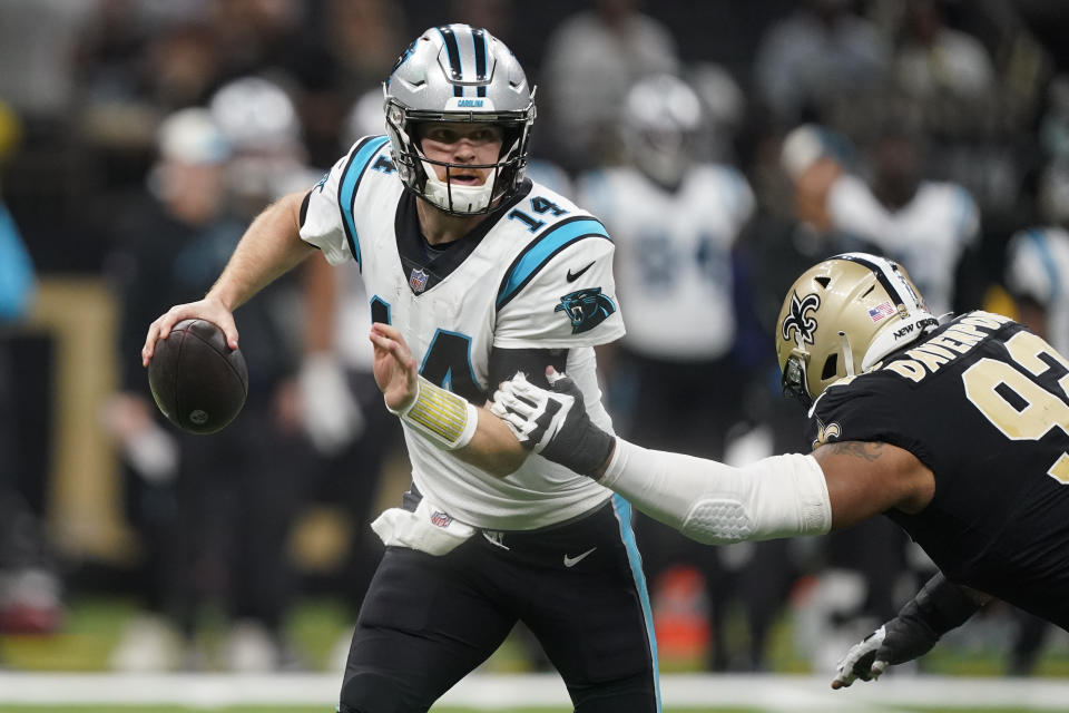 Carolina Panthers quarterback Sam Darnold runs around New Orleans Saints defensive end Marcus Davenport during the first half an NFL football game between the Carolina Panthers and the New Orleans Saints in New Orleans, Sunday, Jan. 8, 2023. (AP Photo/Gerald Herbert)