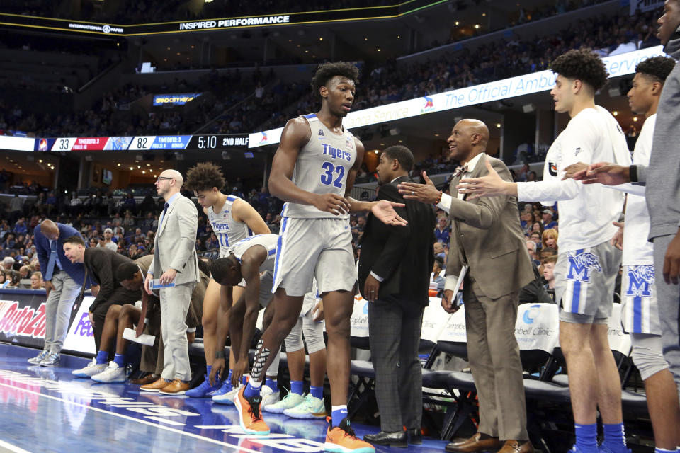 Memphis' James Wiseman (32) is congratulated by teammates as he takes a break during the second half of an NCAA college basketball game against Illinois-Chicago, Friday, Nov. 8, 2019, in Memphis, Tenn. (AP Photo/Karen Pulfer Focht)