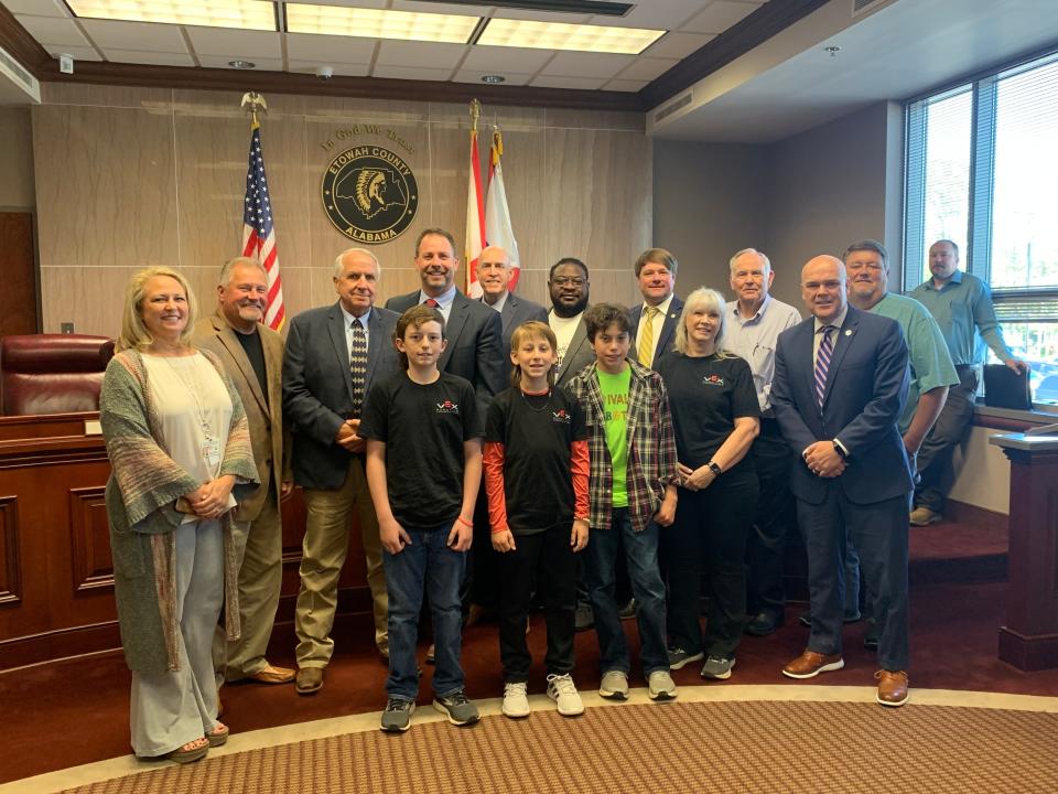 Etowah County Commissioners alongside Etowah County Schools Superintendent Dr. Alan Cosby and members of the Etowah County School Board and the Ivalee Elementary School robotics team.