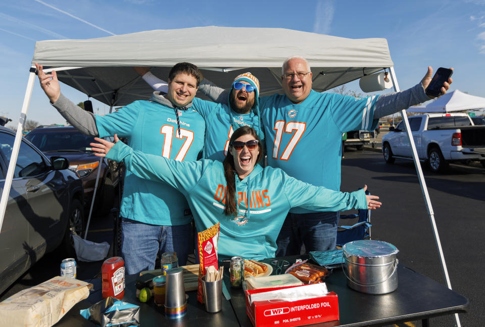 The Taisors family from New York show their support to the Miami Dolphins before the start of an NFL football game against the New York Jets, Friday, Nov. 24, 2023, in East Rutherford, N.J. (David Santiago/Miami Herald via AP)